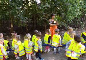 Dzieci na spacerze oglądające liść kasztanowca